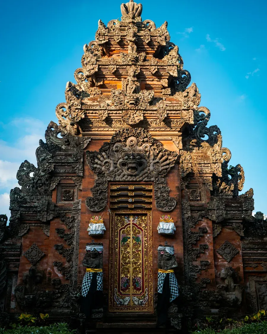 Balinese temple silhouette against a dramatic sky